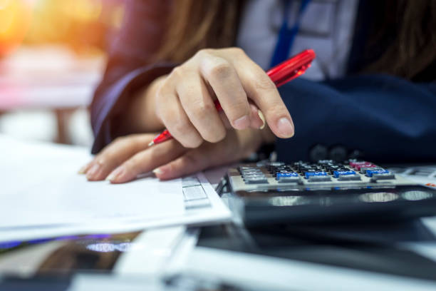 Hands of bank officer calculating loans